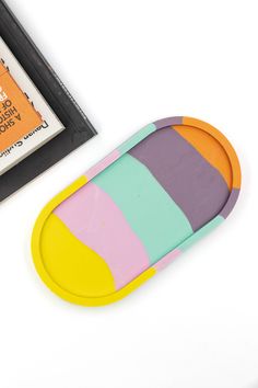 a pair of colorful socks sitting next to a cd case and dvd disc cover on a white surface