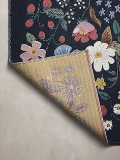 two pieces of fabric with flowers and leaves on them, one has a blue background