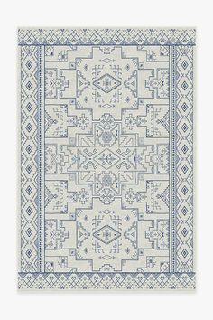 a blue and white rug with an intricate design