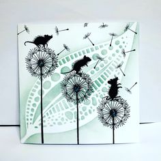 a card with some dandelions and mice on it