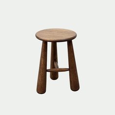 a small wooden stool with two legs on the bottom and one leg up against it