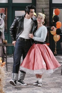 a man and woman are dancing together in front of balloons