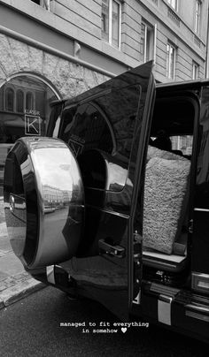 a black and white photo of the back end of a van with its doors open