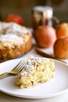 a piece of cake sitting on top of a white plate with a fork next to it