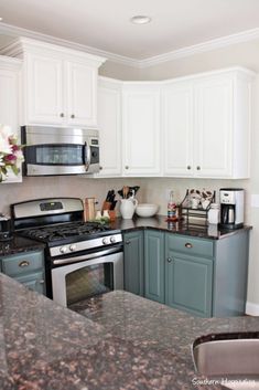 a kitchen with granite counter tops and white cabinets