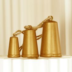 three golden bells tied up with twine