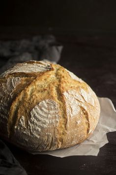 a loaf of bread sitting on top of a piece of wax paper