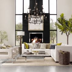 a living room filled with furniture and a fire place in the middle of it's wall