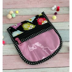 a pink and black purse with polka dots