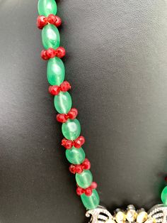 AD Pendent Green Maroon Beads Long Mala with matching earringsColor : SilverSize : Necklace Length : 22 Inches; Earring Length : 2 Inches ApproxStones : CZ Kundan Green Beads Pearls Festive Green Beads With Dangling Details, Festive Green Dangling Beads, Green Czech Glass Necklaces For Party, Green Beaded Necklace With Dangling Beads For Celebration, Festive Green Jewelry With Large Beads, Festive Green Large Beaded Jewelry, Temple Jewelry, Green Beads, Temple Jewellery