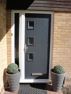 two large planters are next to the front door