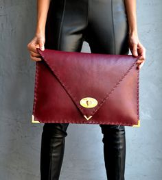 "Bordeaux Symmetria Clutch. The perfect bag for all occasions! Ideal for cocktail and parties or for business meetings depending the size you choose. You can use it as a chic briefcase for your work or as a modern large clutch for a night out. This adorable clutch is handmade out of a genuine, lux Italian bordeaux cow leather. -Small size fits all your essentials, wallet, keys, mobile, cosmetics etc. -Large size fits a 15\" laptop, ipad, portofolio etc and it's perfect as a file folder or as mod Chic Envelope Clutch For Business, Chic Business Envelope Clutch, Elegant Envelope Bag With Laptop Sleeve, Modern Envelope Clutch For Office, Leather Envelope Clutch For Office, Burgundy Leather Bags With Removable Pouch, Elegant Soft Leather Clutch For On-the-go, Formal Leather-lined Pouch Clutch, Modern Red Leather Clutch