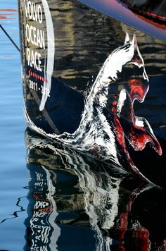 the reflection of a boat in the water