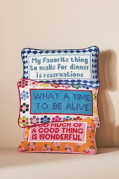 three pillows with different sayings on them