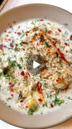 a white bowl filled with soup on top of a table