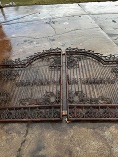 two metal gates sitting on top of a sidewalk