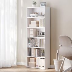 a white bookcase filled with lots of books