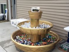 there is a fountain made out of soda cans and ice cubes on the ground