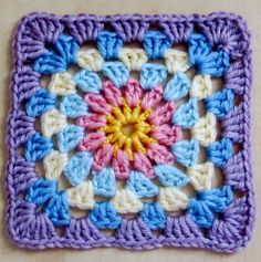 a crocheted square is shown on the table