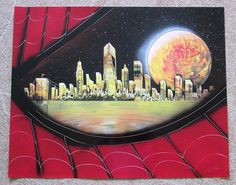 a painting of a city on the side of a building with a spider web in front of it