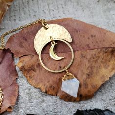 "Introducing: The \"Artemis\" collection. The Artemis features hammered metals, celestial elements and geometric shapes that form a gorgeous collection inspired by Greek goddess Artemis. Perfectly completed with rainbow moonstone daggers. - Brass metal materials - Gold plated stainless steel chain - 10mm Rainbow moonstone pentagon daggers Get the matching earrings here: https://www.etsy.com/listing/1023290792/boho-moon-earrings-artemis-earrings?ref=shop_home_active_2 2021©Wanderlust Hearts desig Bohemian Moon Shaped Brass Jewelry, Handmade Brass Celestial Necklace, Gold Hammered Moonstone Jewelry, Handmade Brass Moon-shaped Necklace, Minimalist Brass Moon Jewelry, Minimalist Moon-shaped Brass Jewelry, Minimalist Moon Shaped Brass Jewelry, Gold Moon-shaped Wire Wrapped Jewelry, Bohemian Hand Forged Moon Jewelry