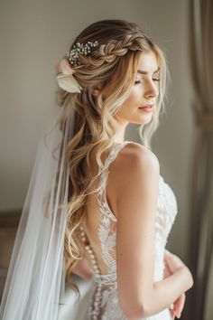 a woman in a wedding dress with a veil on her head