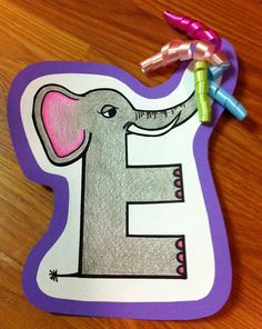 an elephant is on the letter e with crayons