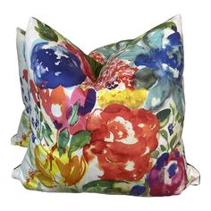 a colorful floral pillow on a white background