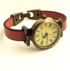 Watch for women vintage style. Simple watch for women. Classic women's watch. Retro minimalist watch for women. Rust orange leather watch. This is a simple and classic wristwatch for women. The watch face is round, 1 inch diameter, antique bronze finish. The quadrant is yellow matte tone and has black numerals and three needles. The band is rust orange, made with European quality leather and a antique bronze fold-over clasp. The band will be made to fit to your wrist. Thank you for your interest Vintage Watch With Leather Strap For Everyday Use, Vintage Brown Watch Accessories With Wrist Strap, Vintage Brown Wrist Strap Watch Accessories, Casual Watches Women, Red Watch With Adjustable Leather Strap, Classic Watch Women, Slim Watches, Retro Minimalist, Simple Watches