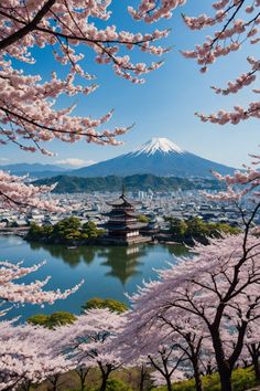 cherry blossoms are blooming in front of the mountains and water with a pagoda on top