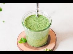 a green smoothie in a mason jar with a straw