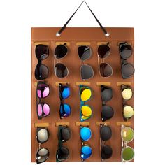 a display case with sunglasses hanging on the wall and various colors of glasses in it