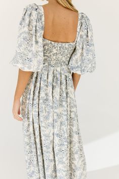 the search for the perfect all-season wedding guest dress is over. this stunning puff sleeve midi dress features a blue floral pattern + a flirty corset-inspired bodice. guaranteed to turn heads with every wear, it’s a must-have for cocktail parties, holiday dinners, or anytime you feel like frolicking. blue floral // midi length, scoop neckline, dramatic puff sleeves, back zipper closure, smocked bodice, fully lined model is 5'8" + wearing a small measurements are approximate + taken while layi Puff Sleeve Floral Dress With Smocked Bodice For Brunch, Brunch Floral Print Midi Dress With Puff Sleeves, Puff Sleeve Midi Dress With Floral Print For Brunch, Puff Sleeve Floral Midi Dress For Brunch, Floral Puff Sleeve Dress With Gathered Sleeves For Brunch, Floral Print Midi Puff Sleeve Dress For Garden Party, Blue Midi Dress With Gathered Sleeves For Brunch, Floral Print Puff Sleeve Midi Dress, Garden Party Floral Print Midi Puff Sleeve Dress