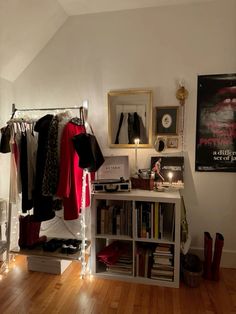 a room with some clothes hanging on the rack and other items sitting on top of it