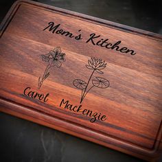 a wooden cutting board with flowers engraved on it