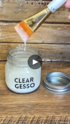 a person is pouring some liquid into a jar with a toothbrush on top of it