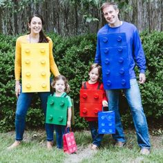 a family dressed up in legos standing next to each other with bags on their backs