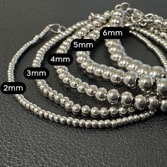 These silver ball bracelets will never tarnish because they are real 925 Sterling Silver with extra thick plating over heavy steel. You can FEEL the quality of these bracelets when you wear them, they have some weight to them (but don't worry, they are still comfy!) You can adjust the size, and they fit up to an 8 inch wrist (size 4X bracelet) We offer our gold bead bracelets in the following bead sizes 2mm silver ball bracelet 3mm silver ball bracelet 4mm silver ball bracelet 5mm silver ball br Sterling Silver Stretch Bracelet With Stackable Round Beads, Silver Multi-strand Bracelets With Spacer Beads, Adjustable Stackable Silver Stretch Bracelet, Adjustable Gold Stretch Bracelet, Nickel Free, Nickel-free Gold Stretch Bracelet With Round Beads, Twisted Bracelet, Ball Bracelet, Gold Bead Bracelets, Paracord Bracelets