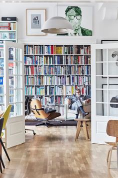 a room filled with lots of books and furniture