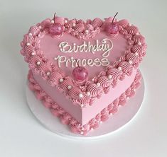 a pink heart shaped cake with the words birthday princess written on it