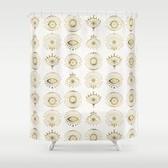 a shower curtain with an eye pattern on the front and bottom, in gold foil