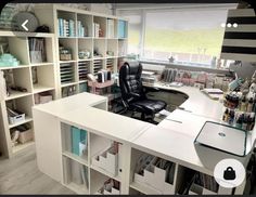 a home office with lots of bookshelves and shelves