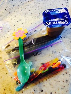 a plastic spoon and some candy on a counter