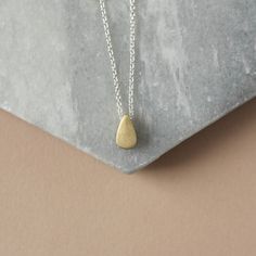 Minimal Mixed Metal Necklace - Two Tone Layering Necklace - Simple Everyday Necklace This trendy mixed metal necklace is perfect for every day and so easy to style with other jewelry. It features a raw brass teardrop paired with sterling silver cable chain for a nice contrast of tones. The teardrop is petite at 9mm tall and 5mm wide but it's also 5mm thick so the charm has some nice depth to it.  The teardrop has been given a brushed textured for some matte gold hue. The charm slides freely alon Gold Teardrop Charm Necklace For Everyday, Everyday Gold Teardrop Charm Necklace, Everyday Teardrop Charm Necklace With Delicate Chain, Gold Teardrop Pendant Necklace, Nickel Free, Nickel-free Teardrop Pendant Necklace For Everyday, Everyday Nickel-free Teardrop Pendant Necklace, Everyday Brass Teardrop Necklace, Everyday Teardrop Brass Necklace, Mixed Metal Necklace