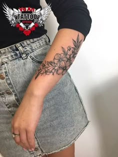 a woman's arm with a flower tattoo on the left side of her body