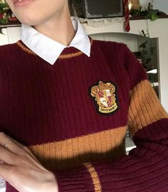 a woman is wearing a harry potter sweater