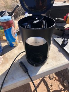 an outdoor grill with the lid open on a table