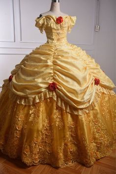 a yellow dress with red roses on it