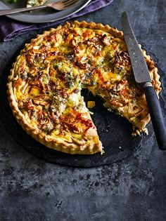 a quiche with one slice missing from it