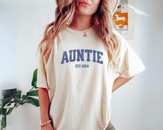 Are you looking for auntie gift? We got you! ✅ ABOUT OUR Custom Aunt to Be Shirt Comfort Color T-shirt  ▸ 100% ring-spun US cotton for long-lasting comfort.  ▸  The garment is sewn around the finished edges with double stitching, making it long-lasting ▸  The garment is dyed after it's been constructed, giving it a soft color and texture ▸ Printed and shipped from the USA ✅ HOW TO ORDER your Aunt Est Shirt 1. Check our photos for sizing and color options. 📏 2. Choose your quantity. Feel free to Christmas Gift For Aunt, Aunt To Be, Aunt Shirt, Gift For Aunt, Photo Care, Aunt Shirts, Auntie Gifts, Aunt Gifts, Oct 11